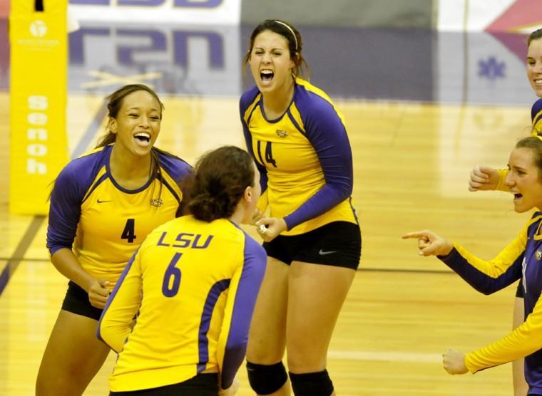 LSU junior middle blocker Desiree Elliott (4), senior outside hitter Madie Jones (6) and sophomore setter Malorie Pardo celebrate a point Sunday, Oct. 14, 2012 during the Tigers' match against Alabama in the PMAC.
 