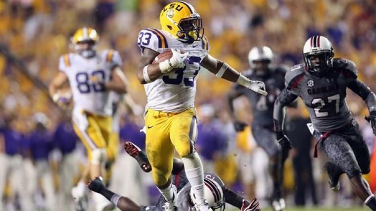 Photo credit: Ronald Martinez (Getty Images). LSU Freshman running back Jeremy Hill (33) eldues South Carolina defenders en-route to a 50-yard touchdown scamper in the fourth quarter of the Tigers' 23-21 victory.
 