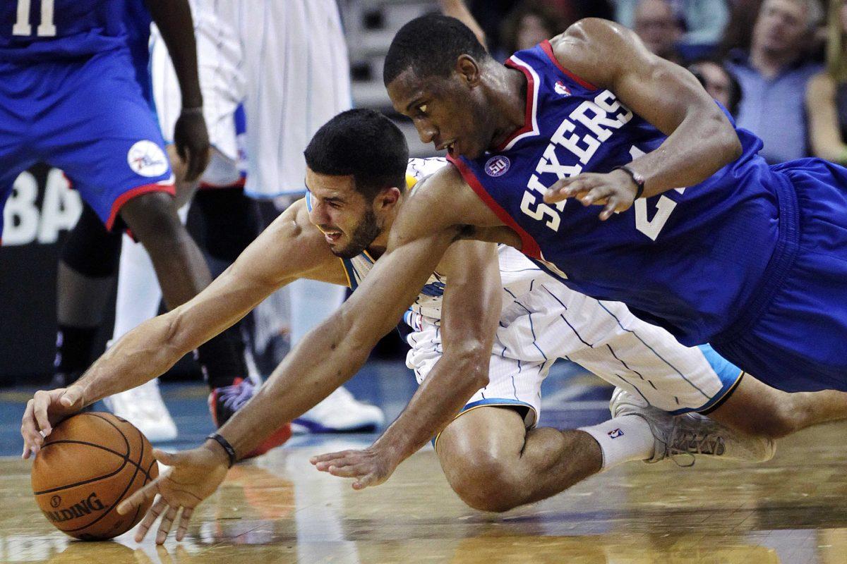 Philadelphia 76ers small forward Thaddeus Young (21) battles for a loose ball with New Orleans Hornets point guard Greivis Vasquez (21) in the first half of an NBA basketball game in New Orleans, Wednesday, Nov. 7, 2012. (AP Photo/Gerald Herbert)