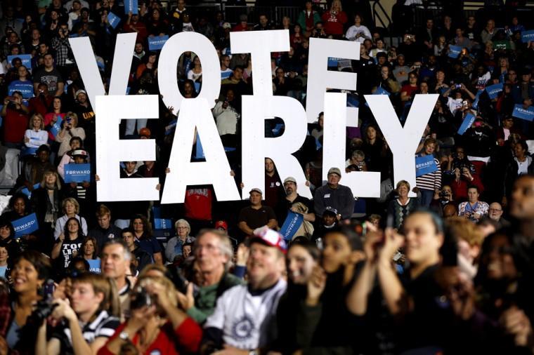 FILE - This Oct. 29, 2012 file photo shows a"Vote Early" sign as former President Bill Clinton spoke at a President Barack Obama campaign rally in Youngstown, Ohio. Stock up on munchies and make sure the batteries in your TV remote are fresh. With this year's presidential election razor-close to the finish, Tuesday could be a long night. Even if the presidency isn't decided until after midnight EST, there will be plenty of clues early in the evening on how things are going for President Barack Obama and Republican Mitt Romney. Obama has more options for piecing the 270 electoral votes needed for victory, so any early setbacks for Romney could be important portents of how the night will end. (AP Photo/Matt Rourke, File)
 