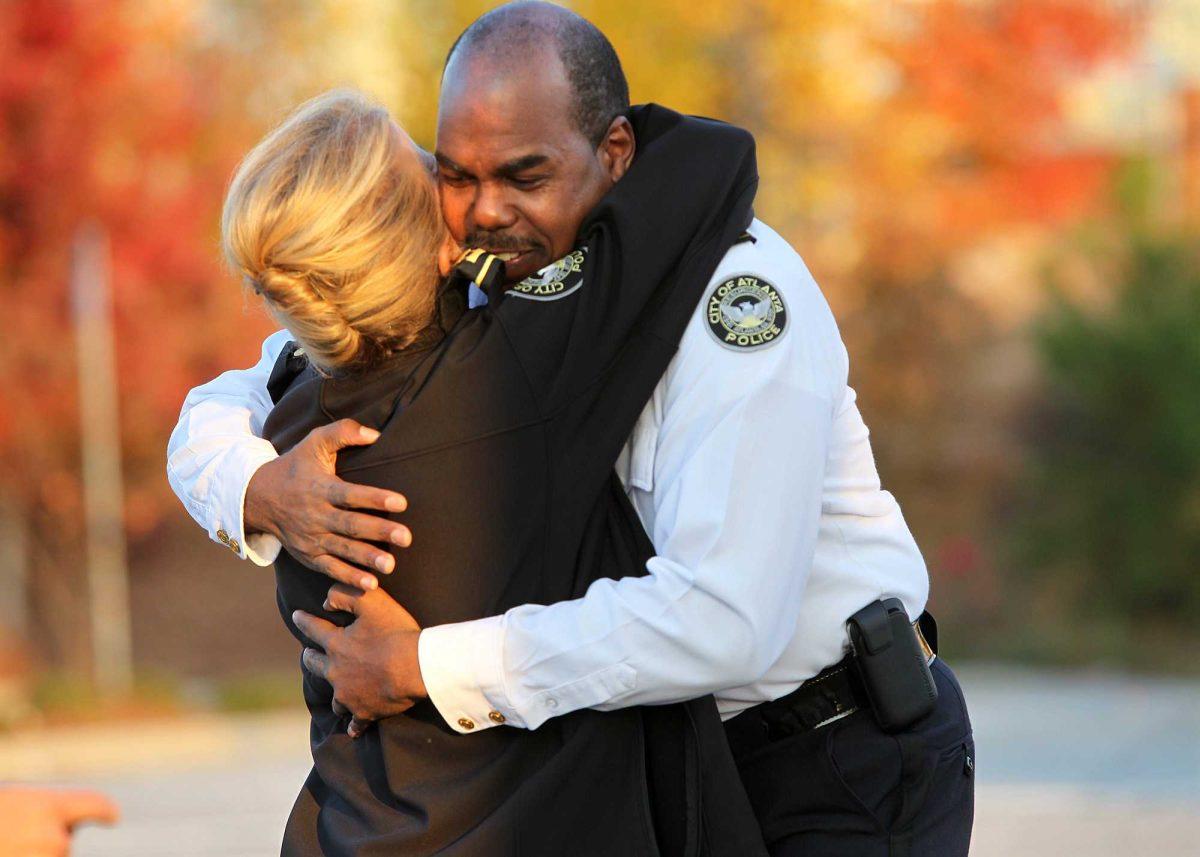 City of Atlanta Capt. Stacie Gibbs, left, and Major Vincent Moore embrace at the crash site of a police helicopter that killed two officers in Atlanta, Sunday, Nov. 4, 2012. The crash occurred Saturday during a search for a missing child. (AP Photo/Atlanta Journal-Constitution, Curtis Compton) MARIETTA DAILY OUT; GWINNETT DAILY POST OUT; LOCAL TV OUT; WXIA-TV OUT; WGCL-TV OUT