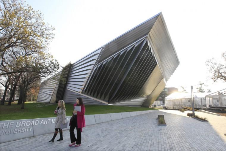 In this Nov. 9, 2012 photo the exterior of the Eli and Edythe Broad Art Museum is seen on the campus of Michigan State University in East Lansing, Mich. The museum features Zaha Hadid's signature look: a facade of pleated stainless steel and glass, which distinguishes it from the traditional brick Collegiate Gothic buildings that surround it on Michigan State's north campus. (AP Photo/Carlos Osorio)
 