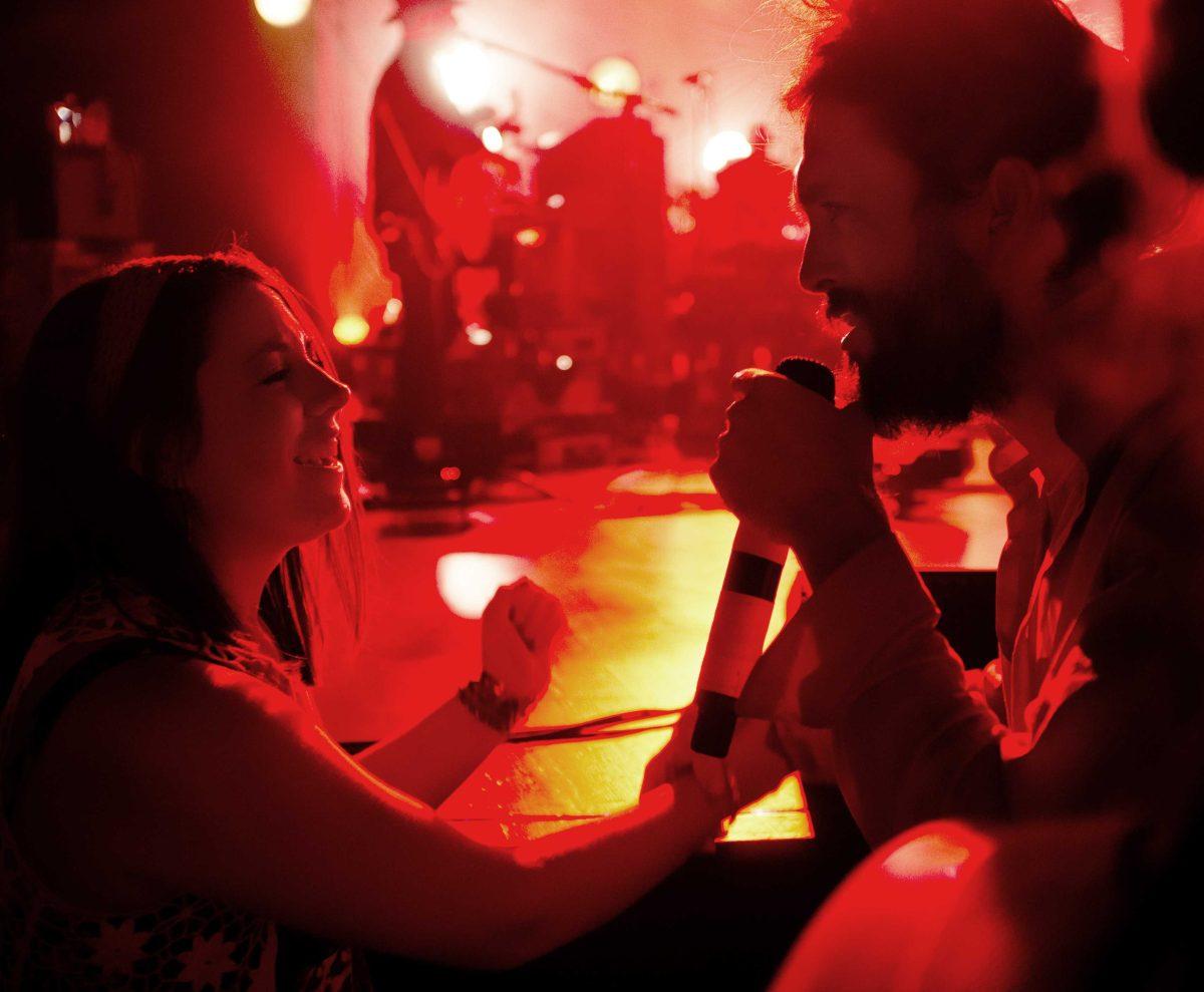 Frontman Alex Ebert serenades a fan in the crowd.