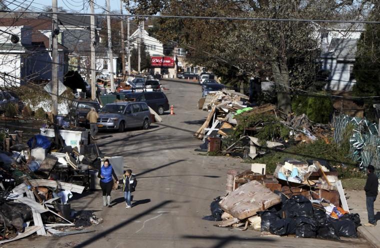 Garbage lies piled on the street in the New Dorp neighborhood of Staten Island, N.Y., Sunday, Nov. 4, 2012, in the aftermath of Superstorm Sandy. (AP Photo/Seth Wenig)
 