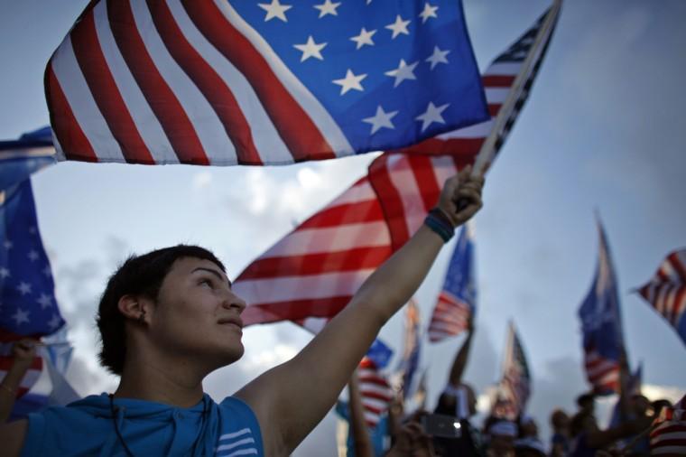 A pro-statehood New Progressive Party supporter waves the U.S. flag during the party's closing campaign rally in San Juan, Puerto Rico, Saturday, Nov. 3, 2012. Voters in the U.S. Commonwealth of Puerto Rico will go the polls on Tuesday, Nov. 6 to weigh in on whether to change the status of their relationship with the United States, the island's central political dilemma, or to leave it unchanged. The two-part referendum is intended to send a message to the U.S. government and resolve a 114-year-old conundrum. (AP Photo/Ricardo Arduengo)
 