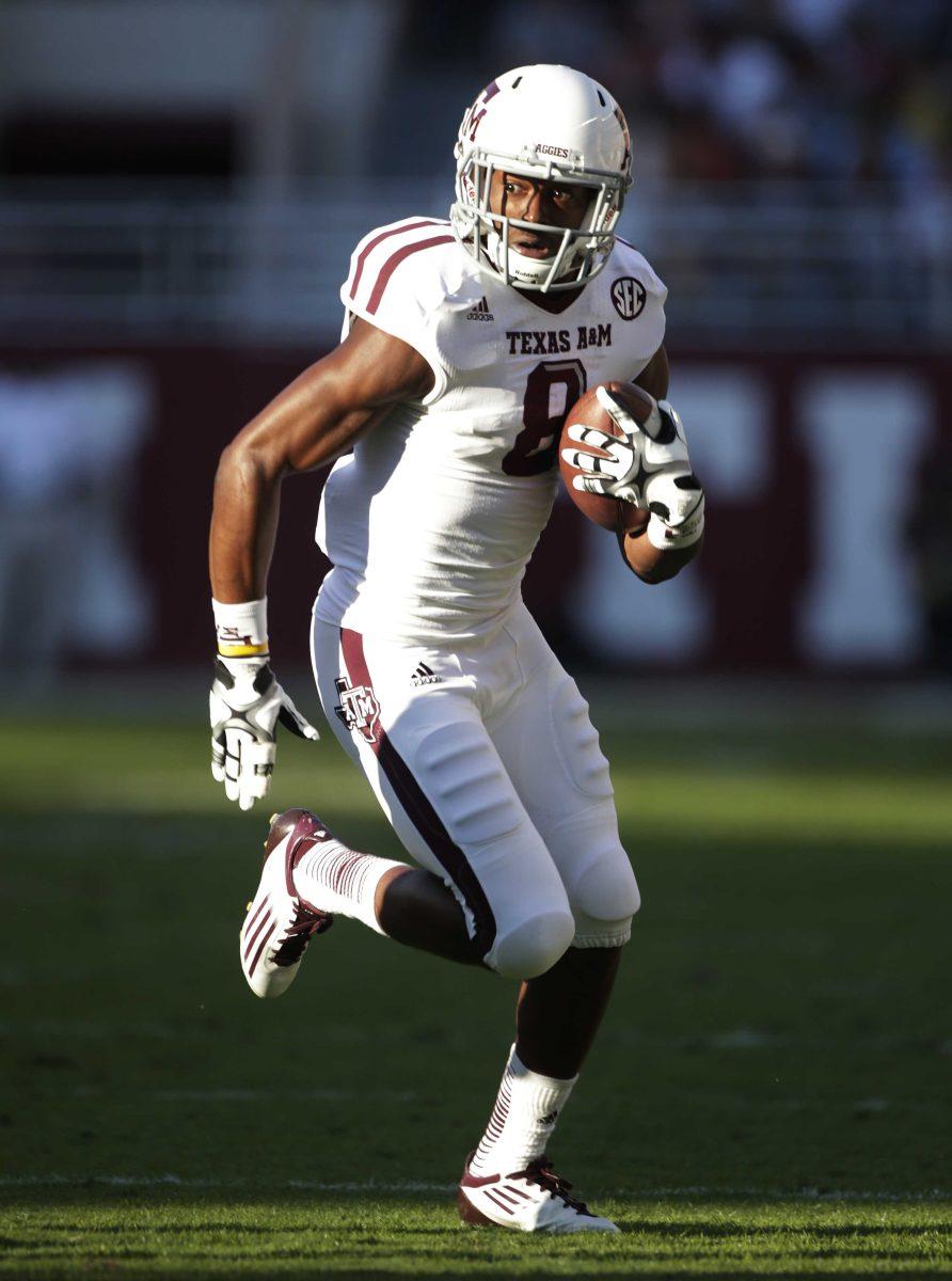 FILE - In this Nov. 10, 2012, file photo, Texas A&amp;M wide receiver Thomas Johnson (8) carries for extra yardage after a reception during the first half of an NCAA college football game against Alabama in Tuscaloosa, Ala. Johnson has been found safe in Dallas after he disappeared from campus days ago. Johnson's mother, Linda Hanks, says A&amp;M University police told her Thursday, Nov. 15, 2012, the 18-year-old is unharmed. (AP Photo/Dave Martin, File)