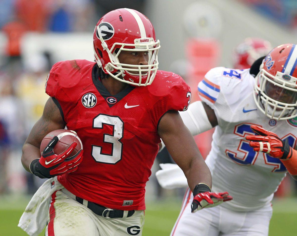 <p>Georgia running back Todd Gurley (3) gets around Florida linebacker Lerentee McCray for yardage during the first half of an NCAA college football game, Saturday, Oct. 27, 2012, in Jacksonville, Fla. (AP Photo/John Raoux)</p>