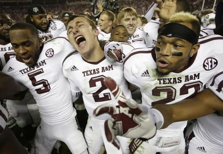 Texas A&amp;M quarterback Johnny Manziel (2) is joined by wide receiver Kenric McNeal (5) and defensive back Dustin Harris (22) as they celebrate after the Aggies defeated top-ranked Alabama 29-24 in an NCAA college football game at Bryant-Denny Stadium in Tuscaloosa, Ala., Saturday, Nov. 10, 2012. (AP Photo/Dave Martin)
 