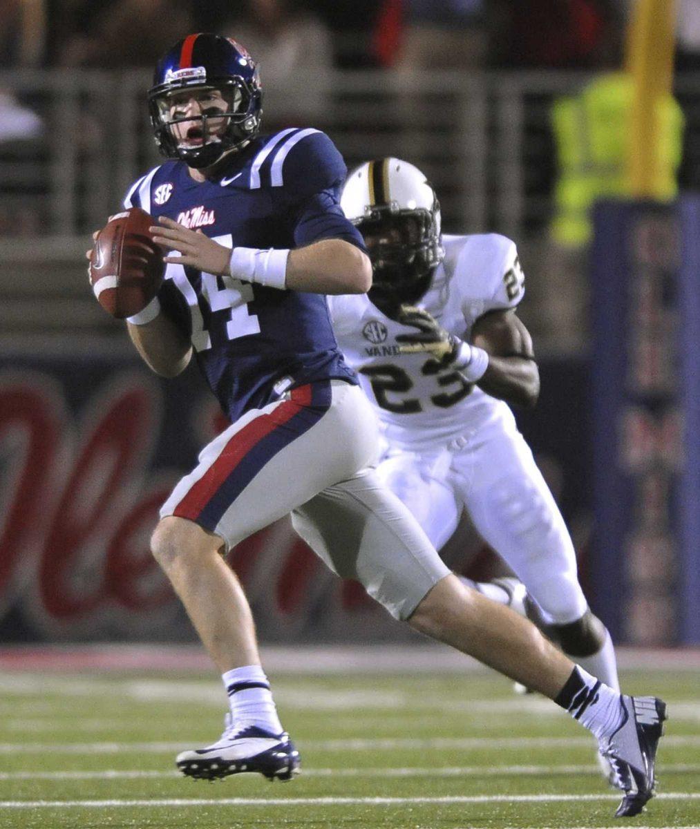 Mississippi quarterback Bo Wallace (14) is chased by Vanderbilt defensive back Andre Hal (23) during an NCAA college football game Saturday, Nov. 10, 2012, in Oxford, Miss. (AP Photo/Oxford Eagle, Bruce Newman) MANDATORY CREDIT NO SALES