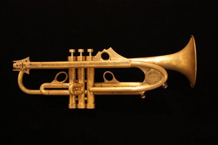 This photo provided by Neal Auction Company shows a specially-made brass trumpet to benefit Satchmo Summerfest, an annual music festival that commemorates the life and legacy of Louis &#8220;Satchmo&#8221; Armstrong, in New Orleans, Aug. 4, 2011. The trumpet was made by Jason Harrelson, a trumpet-maker who has collectors all over the world. The trumpet is being auctioned Saturday, Nov. 17, 2012. It has a fleur-de-lis mouthpiece and the transcription of Louis Armstrong&#8217;s trumpet solo for the song &#8220;A Kiss to Build a Dream On.&#8221; It also has a tuning slide mounted with a New Orleans Water Meter cover. (AP Photo/Neal Auction Company)
 