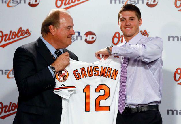 Baltimore Orioles pitcher Kevin Gausman, right, displays his new jersey next to director of amateur scouting Gary Rajsich during a news conference to introduce Gausman as the team's 2012 first-round draft pick, in Baltimore, Friday on July 13, 2012. Photo: Patrick Semansky / AP