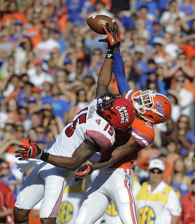 Florida defensive back Marcus Roberson (5) breaks up a pass intended for Louisiana-Lafayette wide receiver Jamal Robinson (15) during the second half of an NCAA college football game in Gainesville, Fla., Saturday, Nov. 10, 2012. Florida won 27-20. (AP Photo/Phil Sandlin)
 