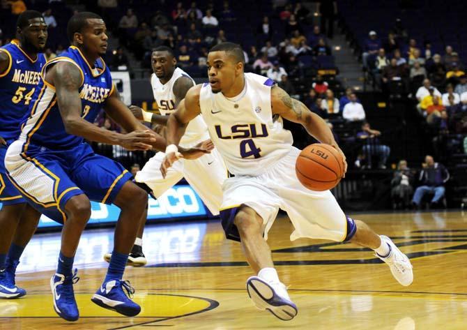 Corban Collins, LSU freshman guard, dribbles past a McNeese State defender Tuesday, Nov. 13, during the LSU vs. McNeese State game.
 