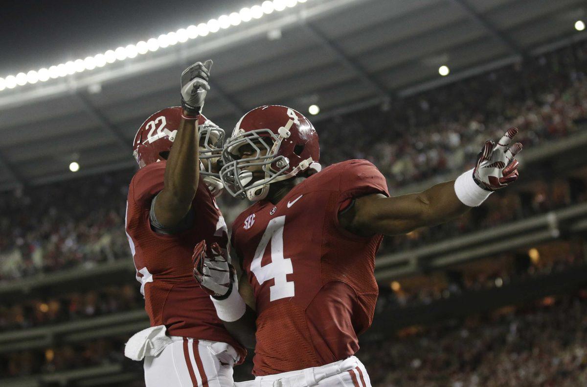 Alabama running back T.J. Yeldon (4) celebrates with wide receiver Christion Jones (22) after scoring against Mississippi State during the first half of an NCAA college football game at Bryant-Denny Stadium in Tuscaloosa, Ala., Saturday, Oct. 27, 2012. (AP Photo/Dave Martin)