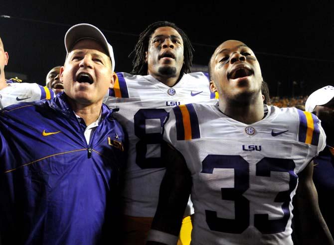 LSU head coach Les Miles, sophomore tight end Nic Jacobs (84) and freshman running back Jeremy Hill (33) sing the LSU alma mater Saturday, Oct. 13, 2012 after the Tigers' 23-21 win against South Carolina in Tiger Stadium.