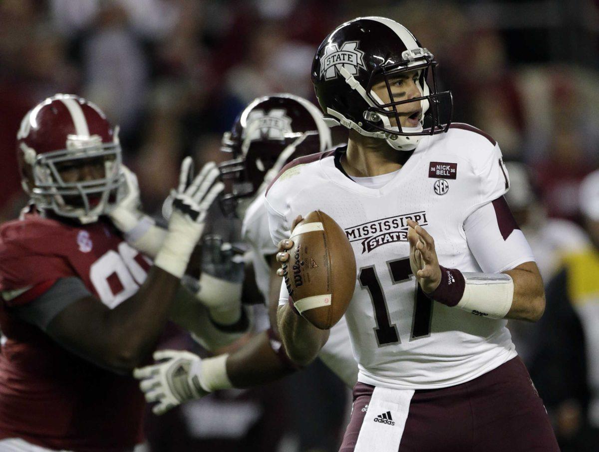 Mississippi State quarterback Tyler Russell (17) looks for a receiver as Alabama defensive lineman Quinton Dial (90) pursues during the first half of an NCAA college football game at Bryant-Denny Stadium in Tuscaloosa, Ala., Saturday, Oct. 27, 2012. (AP Photo/Dave Martin)