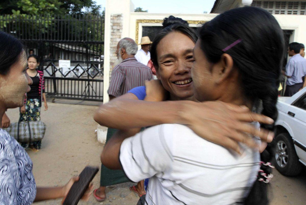 A Myanmar prisoner, center, is welcomed by her relative outside Insein prison in Yangon, Myanmar after the political prisoners were released Thursday, Nov. 15, 2012. Myanmar reformist government ordered more than 450 prisoners freed Thursday in an amnesty apparently intended as a goodwill gesture ahead of an historic visit by President Barack Obama next week. (AP Photo/Khin Maung Win)