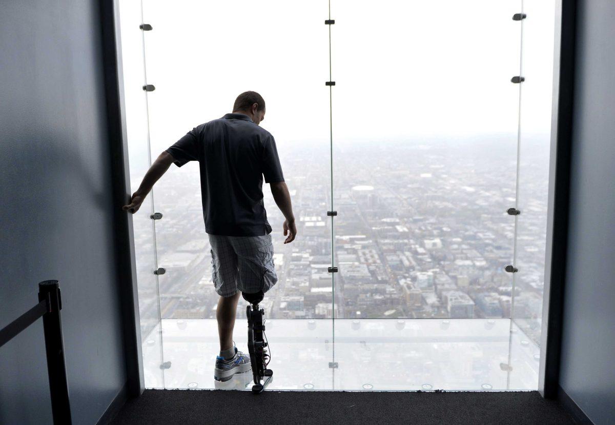 Zac Vawter, fitted with an experimental "bionic" leg, looks out onto the Ledge at the Willis Tower, Thursday, Oct. 25, 2012 in Chicago. Vawter is training for the world's tallest stair-climbing event where he'll attempt to climb 103 flights to the top of the Willis Tower using the new prosthesis. Vawter will put his bionic leg to the ultimate test Sunday, Nov. 4, when he attempts to climb 103 flights of stairs to the top of Chicago's Willis Tower, one of the world's tallest skyscrapers. If all goes well, he'll make history with the bionic leg's public debut. (AP Photo/Brian Kersey)