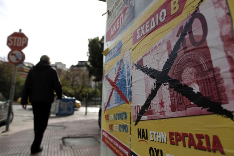 A man walks past a poster in central Athens that reads "Yes to Work. No to the Euro" on Monday, Nov. 12, 2012. Greece's parliament late Sunday approved the 2013 austerity budget as part of major cuts demanded by international rescue lenders to continue paying loan installments to the near-bankrupt eurozone nation. (AP Photo/Petros Giannakouris)
 