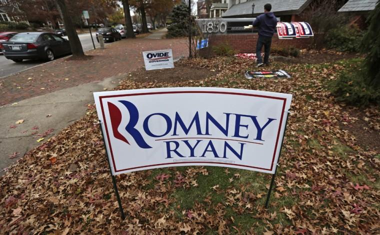 A campaign worker removes candidate signs from in front of Mitt Romney's campaign office in Manchester, N.H., Wednesday, Nov. 7, 2012. Romney conceded the presidential election shortly after midnight Wednesday. (AP Photo/Charles Krupa)
 