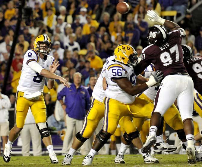 LSU junior quarterback Zach Mettenberger (8) tosses the ball beyond the reach of MSU senior defensive lineman Josh Boyd (97) during the Tiger's 37-17 win over the Bulldogs on November 10, 2012.
 