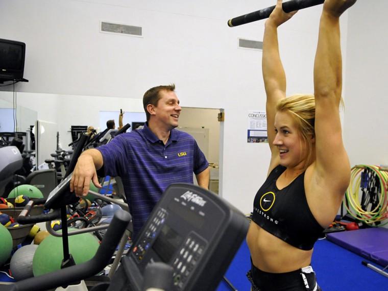 LSU's new associate head coach Jay Clark jokes with junior Sarie Morrison after practice Wednesday, Nov. 7, 2012 in the Carl Maddox Field House.
 