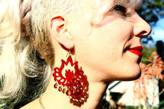 Jewelry designer Lauren Collignon models her Flaming Lotus Earrings Friday, Nov. 2, 2012.
 