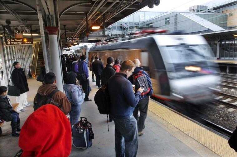 Commuters wait as a train arrives early Monday, Nov. 5, 2012, in Trenton, N.J. A week after the storm surge from Superstorm Sandy knocked out power and flooded much of the region, trains are running a partial schedule on NJ Transit's Northeast Corridor between Trenton and New York City. Earlier Gov. Chris Christie announced the federal government will be providing rail cars to help NJ Transit get train service up and running. The governor said 25 percent of the system's rail cars were in yards that flooded. (AP Photo/Mel Evans)
 