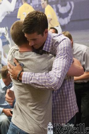 Sophomore pitcher Kevin Gausman hugs senior infielder Tyler Hanover after the Baltimore Orioles selected Gausman as the fourth overall pick in the 2012 MLB Draft.