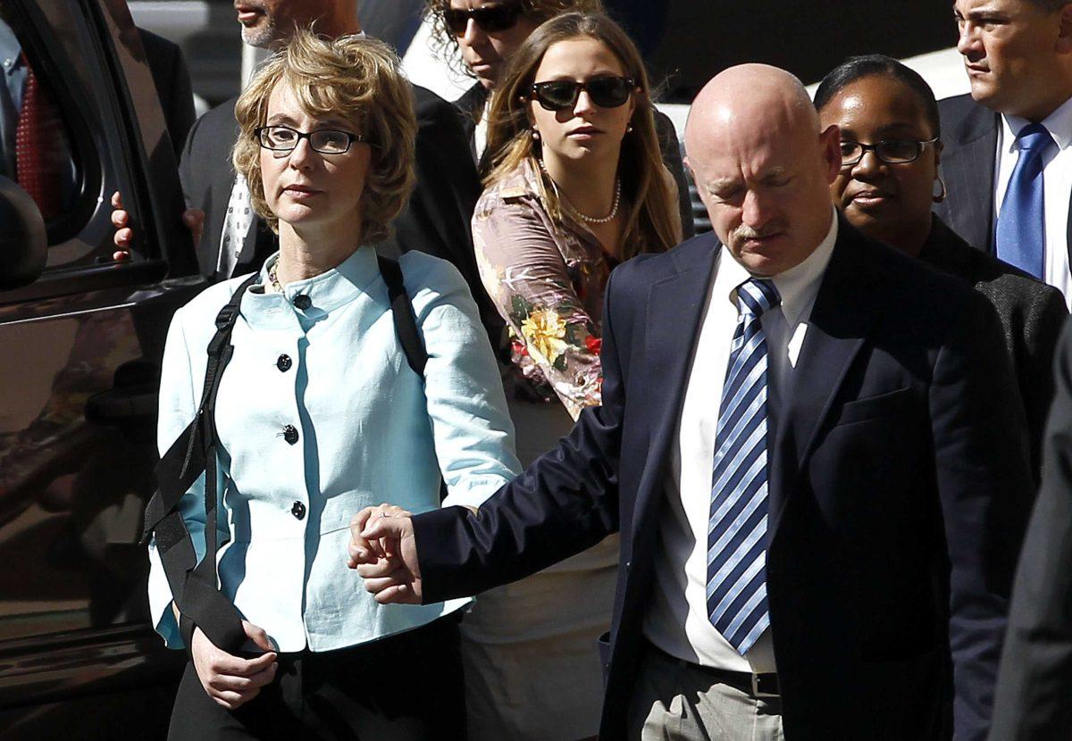 Former Democratic Rep. Gabrielle Giffords, left, and her husband Mark Kelly leave after the sentencing of Jared Loughner, in back of U.S. District Court Thursday, Nov. 8, 2012, in Tucson, Ariz. U.S. District Judge Larry Burns sentenced Jared Lee Loughner, 24, to life in prison, for the January 2011 attack that left six people dead and Giffords and others wounded. Loughner pleaded guilty to federal charges under an agreement that guarantees he will spend the rest of his life in prison without the possibility of parole. (AP Photo/Ross D. Franklin)