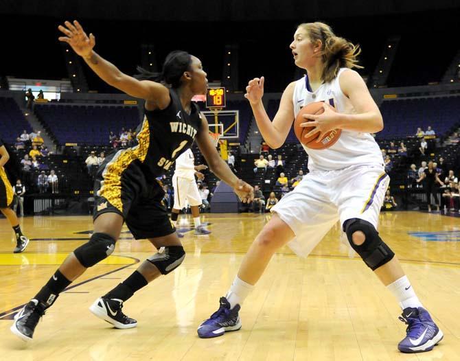 LSU junior forward Theresa Plaisance (55) fakes out Wichita State senior gaurd Jasmin Jones (1) during the Tiger's 72-70 win over the Shockers on November 11, 2012.