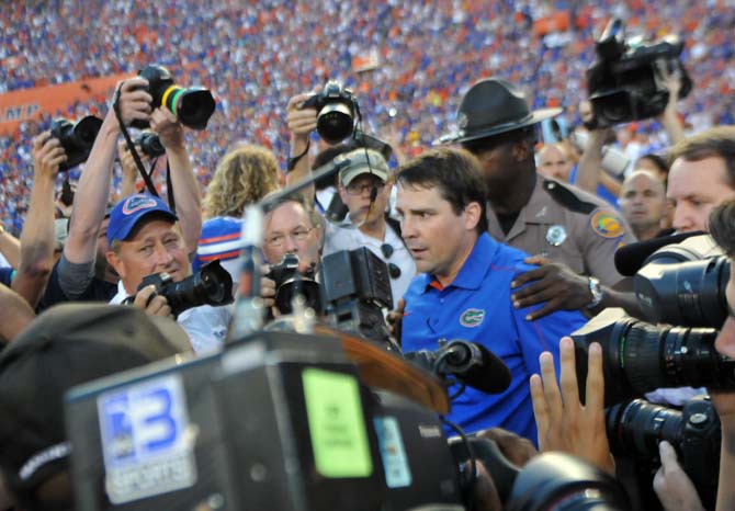 Florida head coach Will Muschamp is swarmed by media Saturday, Oct. 6, 2012 after the Tigers' 14-6 loss to the Gators in Ben Hill Griffin Stadium in Gainesville.