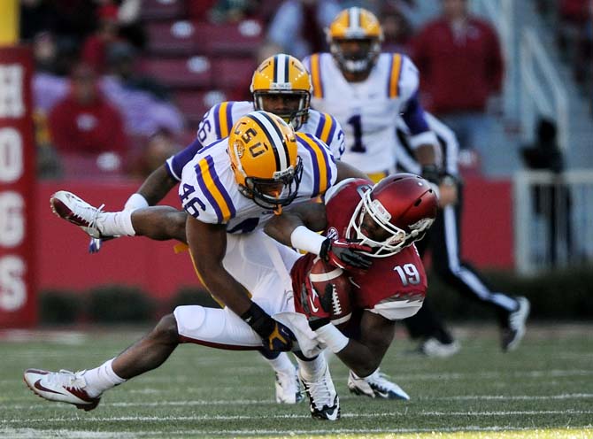 LSU junior linebacker Kevin Minter (46) slams into Arkansas junior wide receiver Javontee Herndon (19) during the Tiger's 20-13 win over the Razorbacks on November 23, 2012.