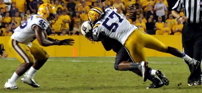 LSU unior linebacker Lamin Barrow (57) tackles a South Carolina receiver during the Tiger's 23-21 win over the Gamecocks on October 13, 2012.