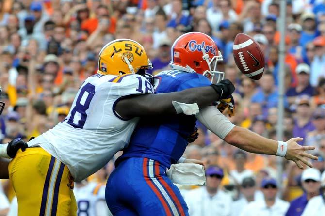 LSU junior defensive tackle Bennie Logan (18) forces Florida quarterback Jeff Driskel (6) to fumble Saturday, Oct. 6, 2012 during the Tigers' 14-6 loss to the Gators in Ben Hill Griffin Stadium in Gainesville. LSU junior defensive end Barkevious Mingo recovered the fumble.