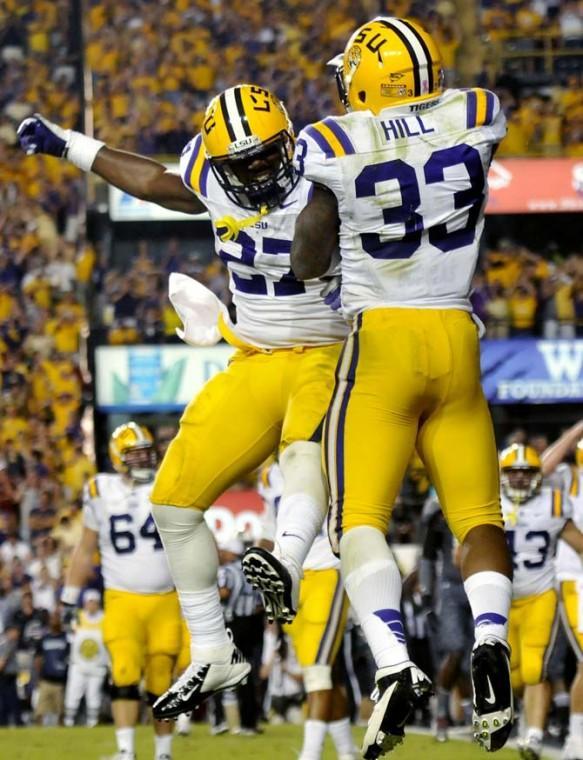 Freshman running back Jeremy Hill (33) and sophomore running back Kenny Hilliard (27) celebrate after Hill's touchdown during the game against South Carolina on October 11, 2012.