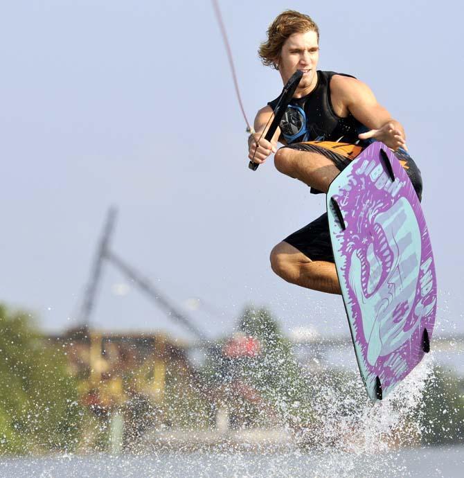 Daniel Kopsco, electircal engineering junior, jumps off a wave during a wakeboarding team practice on October 12, 2012.