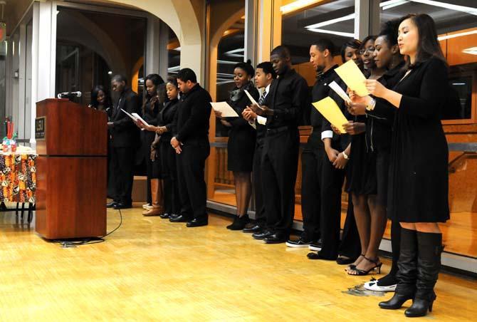 Officers of the African American Cultural Center recite the Kwanzaa Pledge on Tuesday night during the group's Pre-Kwanzaa Celebration in the Atchafalaya Rooom in the Student Union.