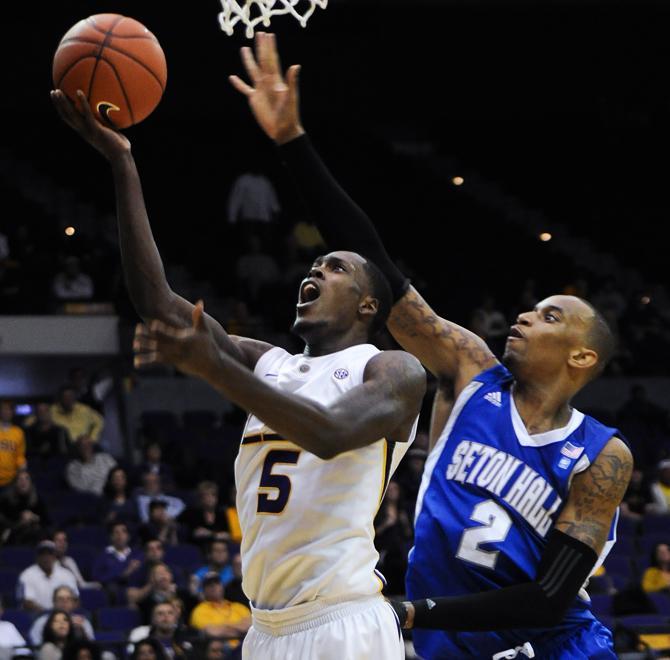 LSU junior forward Shavon Coleman (5) jumps past Seton Hall forward Brandon Mobley (2) to make a shot Thursday, Nov. 29, 2012, during the Tigers' 72-67 victory against the Pirates in the PMAC.