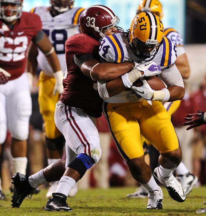 LSU sophomore tight end Nic Jacobs (84) fights for extra yardage Saturday, Nov. 3, 2012, during the Tigers' 21-17 loss to Alabama in Tiger Stadium.