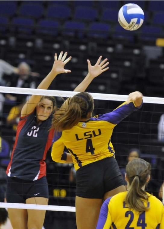 Junior middle blocker Desiree Elliott (4) spikes the ball Sunday, November 4, 2012 during the Tigers' 3-2 victory versus Ole Miss.