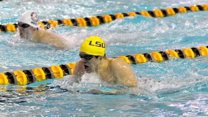 LSU senior Nick Kunkel swims against Alabama junior Andrew Wrist in the 200-yard individual medley during a swim meet on November 2, 2012.