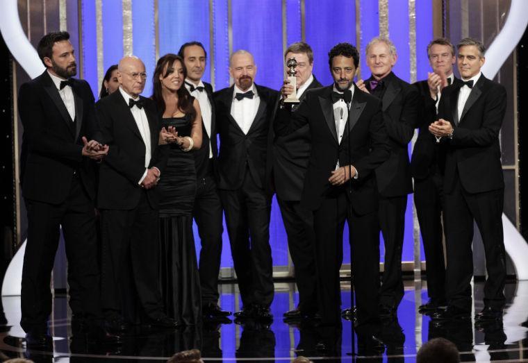 This image released by NBC shows producer Grant Heslov, foreground, with the cast and crew of "Argo" after the film won best drama during the 70th Annual Golden Globe Awards at the Beverly Hilton Hotel on Jan. 13, 2013, in Beverly Hills, Calif. (AP Photo/NBC, Paul Drinkwater)
 