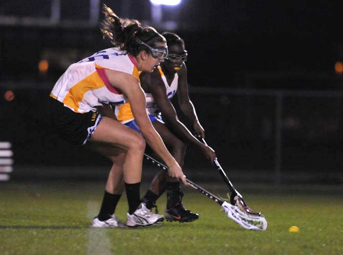 Lacrosse players run down the field Tuesday, Jan. 29, 2013 at the UREC Sport &amp; Adventure Complex fields. The women's lacrosse club was dissolved two years ago, but was reformed last year thanks to renewed student intrest.
 