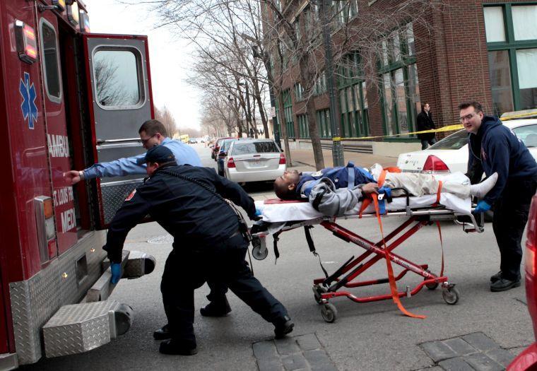 Police and emergency personnel transport a man to an ambulance after a shooting at Stephens Institute of Business and Arts on Washington Avenue in St. Louis on Tuesday, Jan. 15, 2013. A part-time student strode into the office of a longtime administrator at the school and shot the man in the chest, creating panic in the school before turning the gun on himself, police said. (AP Photo/St. Louis Post-Dispatch, David Carson) EDWARDSVILLE INTELLIGENCER OUT; THE ALTON TELEGRAPH OUT
 