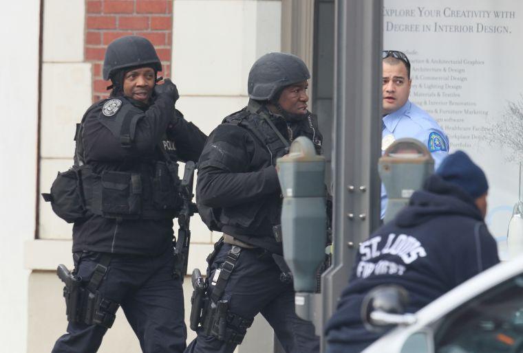 Police respond to the report of a shooting at Stevens Institute of Business and Arts in St. Louis on Tuesday, Jan. 15, 2013. Police say a gunman entered the school and shot a person in the chest, then shot himself. Everyone inside the building was evacuated, though police were checking the school to make sure the building was empty. The conditions of the shooting victims were not immediately known. (AP Photo/St. Louis Post-Dispatch, David Carson)
 