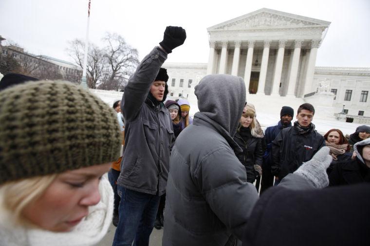 FILE - In this Sunday, Jan. 22, 2012 file photo, people with the group "Bound 4 Life" pray for an end to abortions outside of the U.S. Supreme Court in Washington on the 39th anniversary of the court's landmark Roe vs. Wade decision which legalized abortion. (AP Photo/Jacquelyn Martin, File)
 