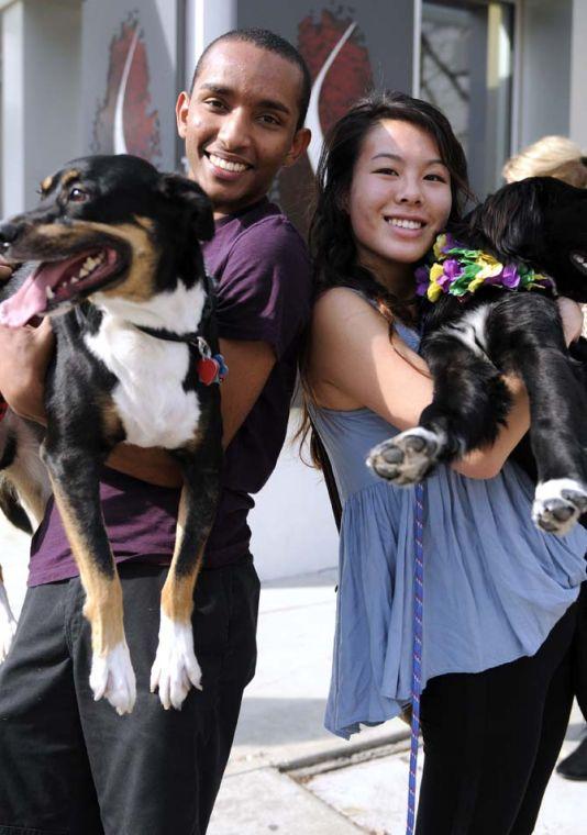 LSU chemical engineering freshman Fasil Lisan (left) and prenursing freshman Julie Liu (right) smile with their dogs during the Krewe of Mutts dog parade downtown on Jan. 27, 2013.
 