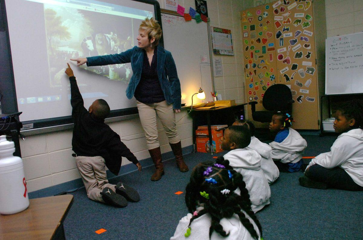 Julius Patrick Elementary School pupil Terry Lotts, front left, points out a duck to Alexandria Museum of Art resident artist Cindy Blair Wednesday, Dec. 19, 2012, in Alexandria, La. The Alexandria Museum of Art is working with local elementary schools to provide Visual Thinking Strategies (VTS) training and implementation. (AP Photo/The Daily Town Talk, Melinda Martinez) NO SALES