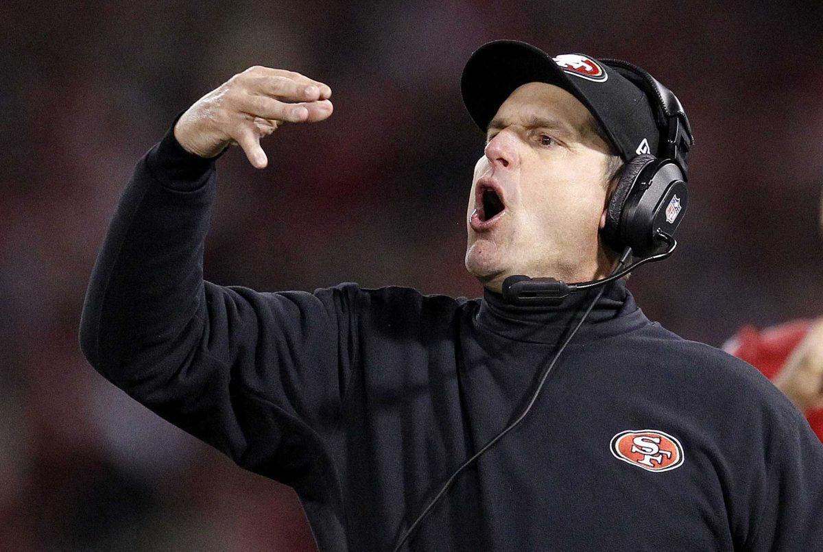 FILE - In this Jan. 12, 2013 file photo, San Francisco 49ers head coach Jim Harbaugh yells from thne sideline during the second half of an NFC divisional playoff NFL football game against the Green Bay Packers in San Francisco. The Harbaughs, San Francisco's Jim and Baltimore's John, will be the first pair of brothers to coach against each other in the NFL title game. (AP Photo/Tony Avelar, File)